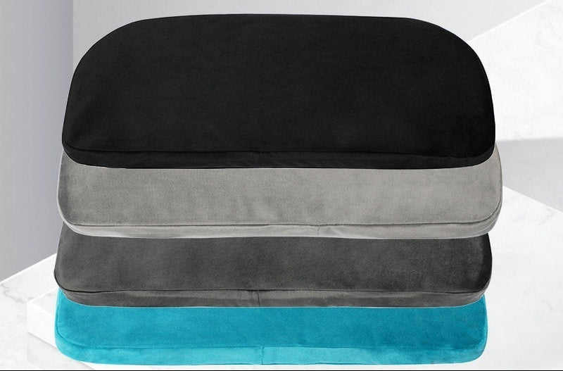 Stack of black, gray, and blue pillows with text about removable and washable pillowcases.
