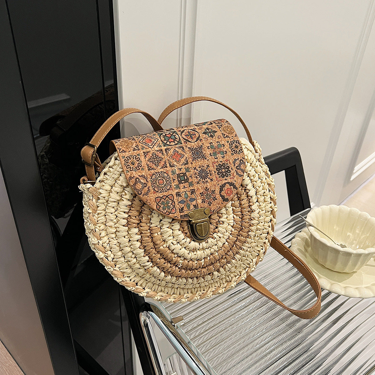 Woven handbag with patterned flap on a surface