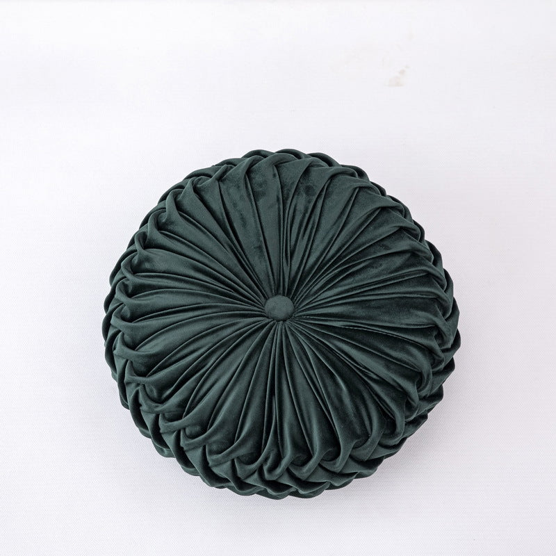 Green round pleated pillow on a white background