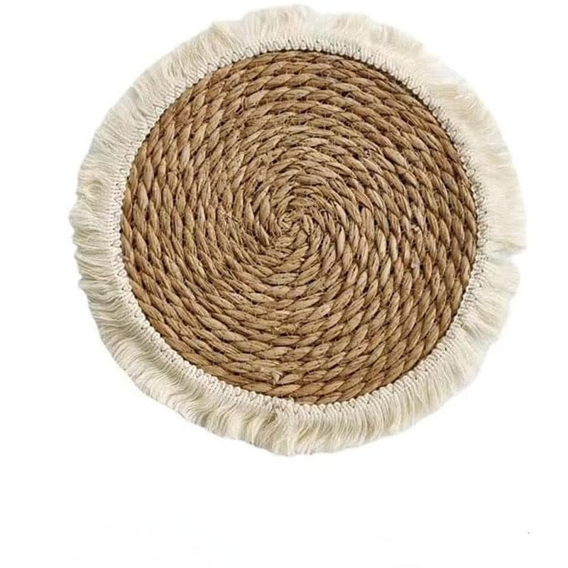 Round woven mat with fringed edge on a white background