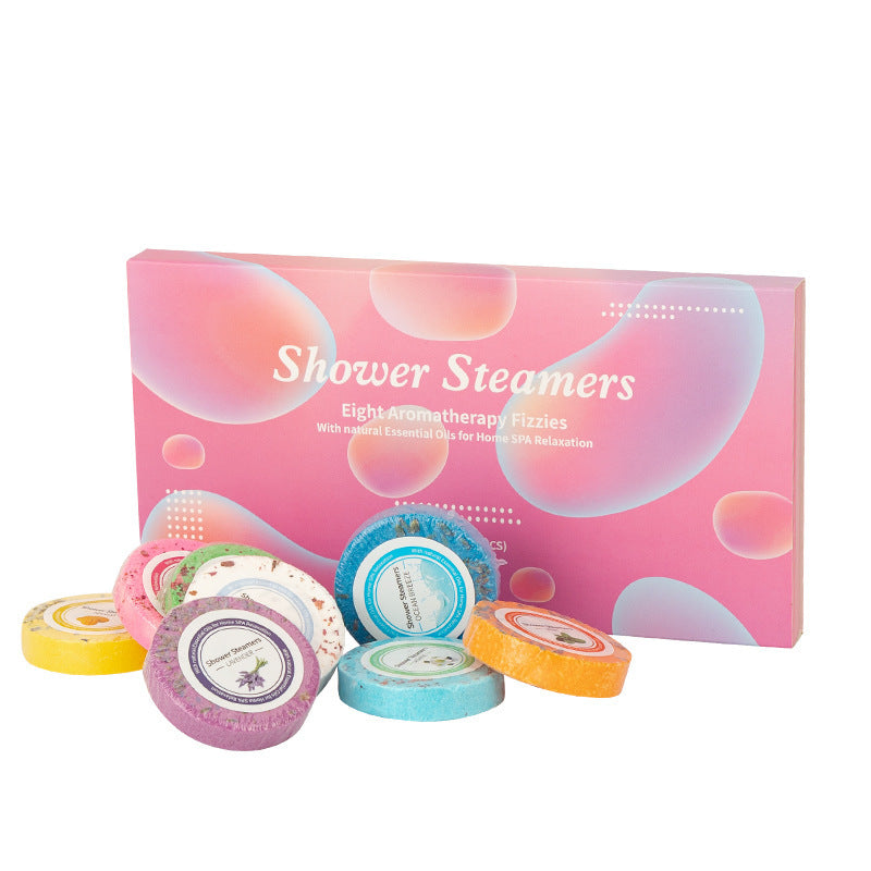 Set of colorful shower steamers with a pink packaging box labeled 'Shower Steamers' on a white background.