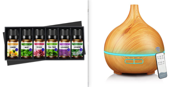 Set of essential oil bottles and a wooden diffuser on a white background