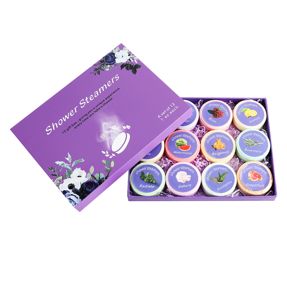 Set of shower steamers in a purple box with floral designs on a white background