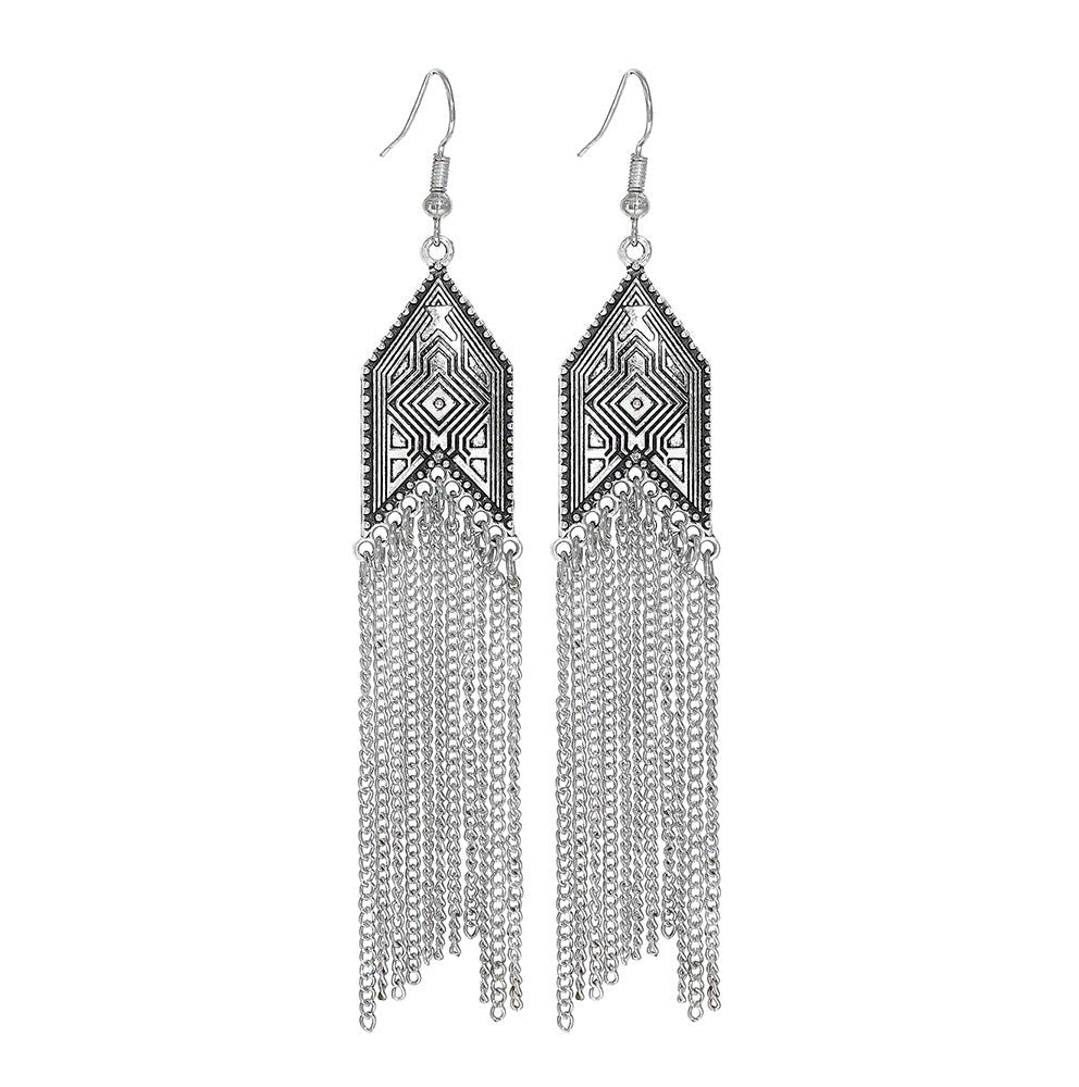 Pair of silver fringe earrings on a white background