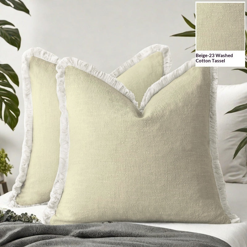 Beige pillows with white tassels on a bed, with a close-up inset of the fabric texture.