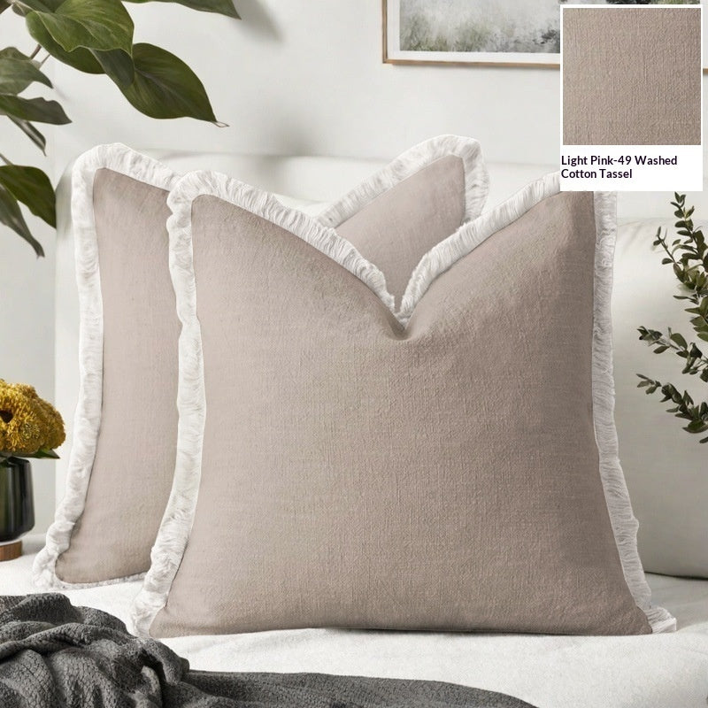 Beige pillows with white tassels on a bed, with a close-up inset of the fabric texture.