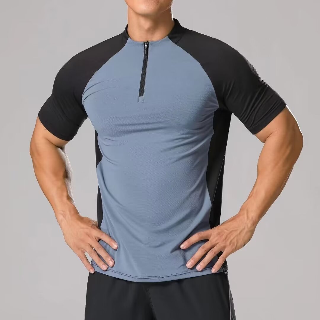 Person wearing a gray and black athletic shirt on a gray background