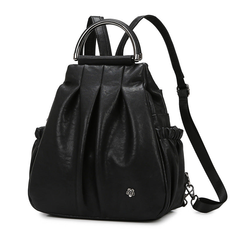 Black leather backpack with a drawstring top on a white background