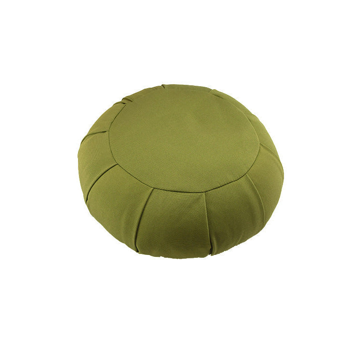 Green meditation cushion on a white background