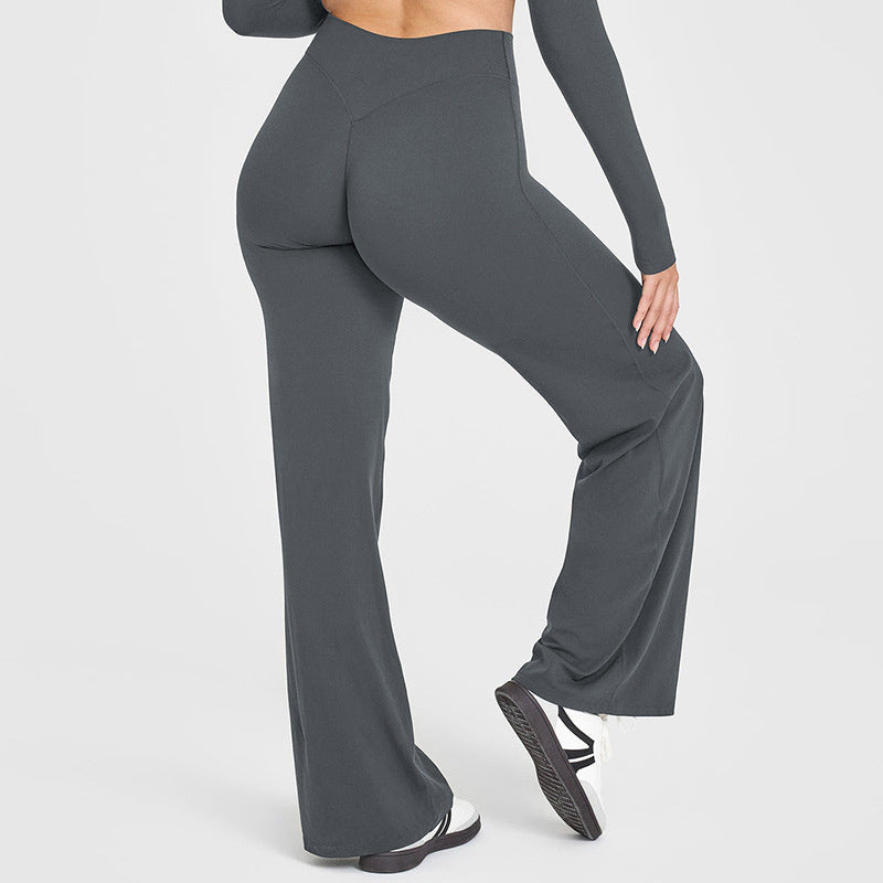 Person wearing gray high-waisted leggings on a white background