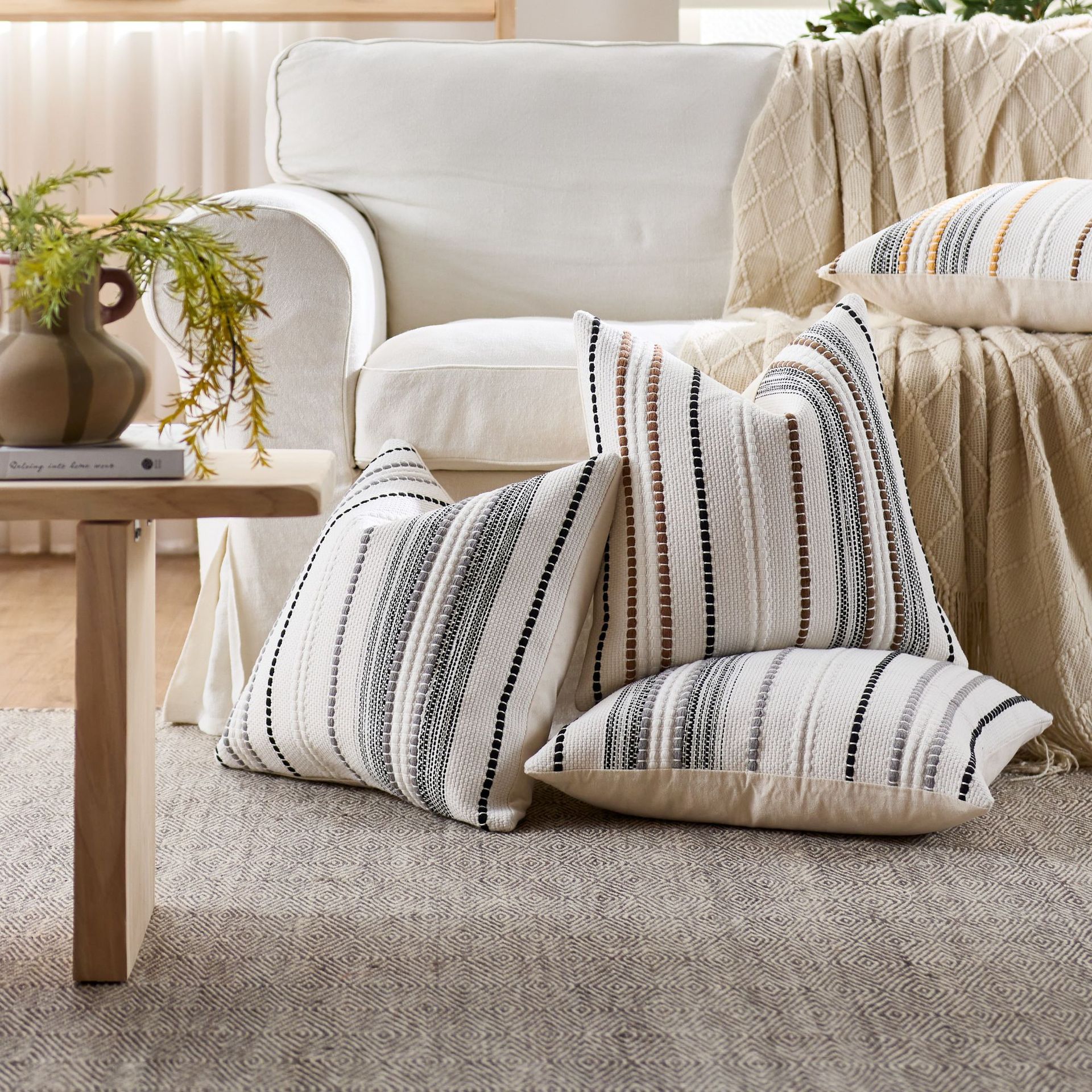 Striped pillows on a couch in a living room setting