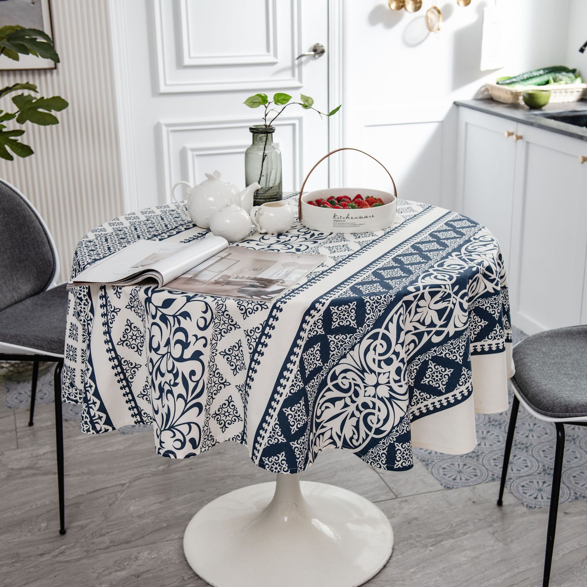 Table with a blue and white patterned tablecloth in a kitchen setting.