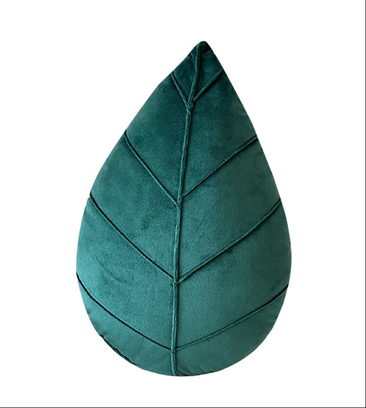 Teal leaf-shaped pillow on a white background