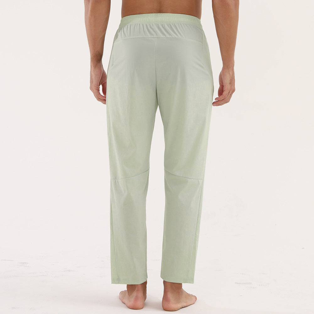 Light green lounge pants worn by a person on a white background