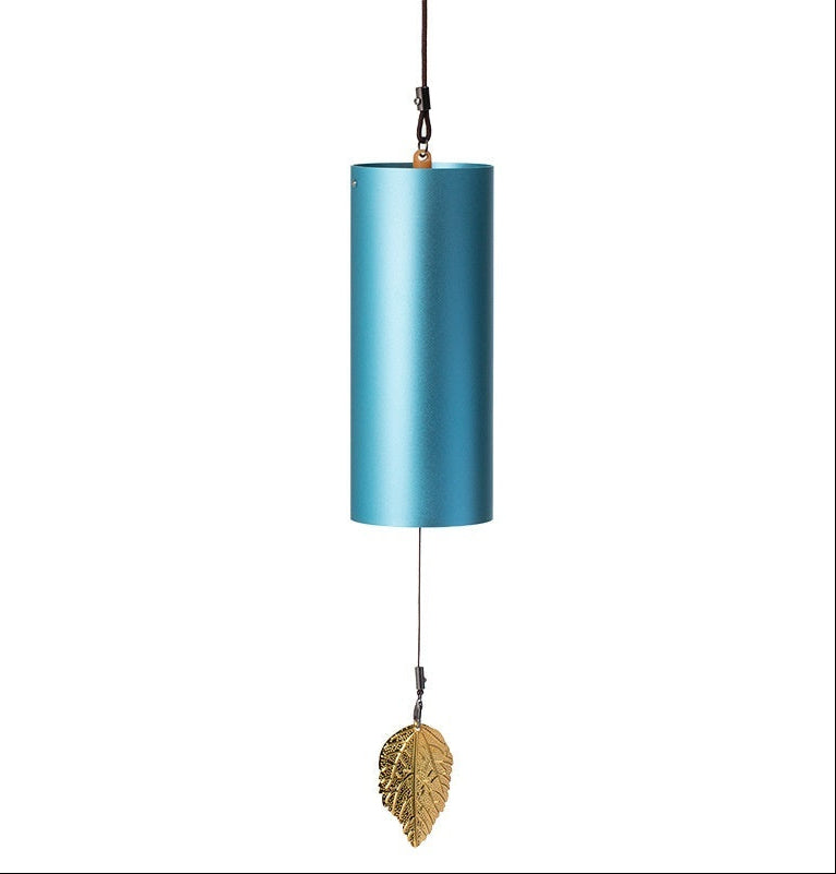 Blue cylindrical wind chime with a gold leaf charm on a white background