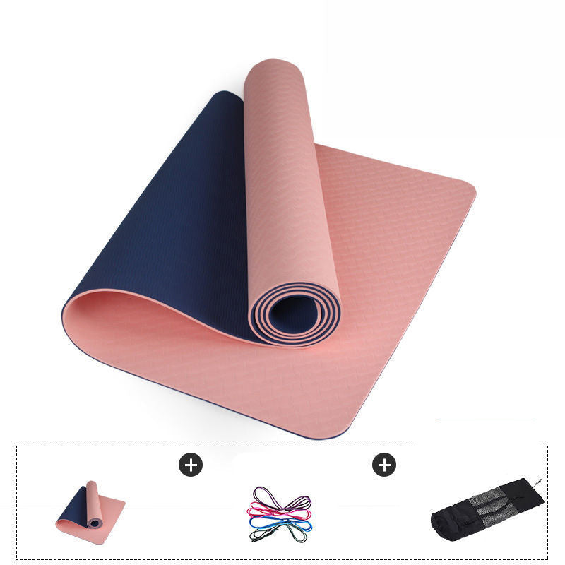 Two rolled-up yoga mats, one blue and one pink, on a white background.