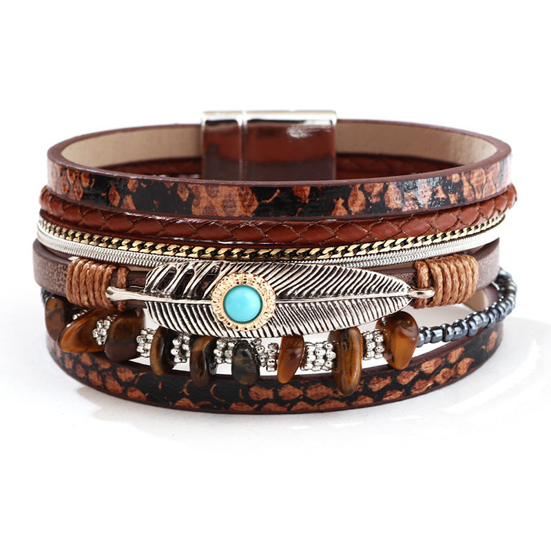 Multistrand bracelet with leather and metal components on a white background