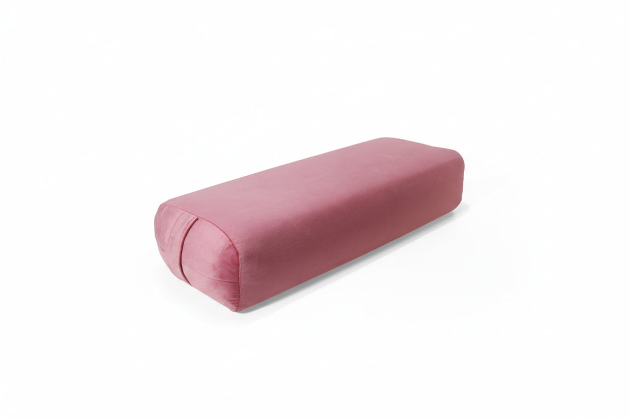 Pink cylindrical pillow on a white background