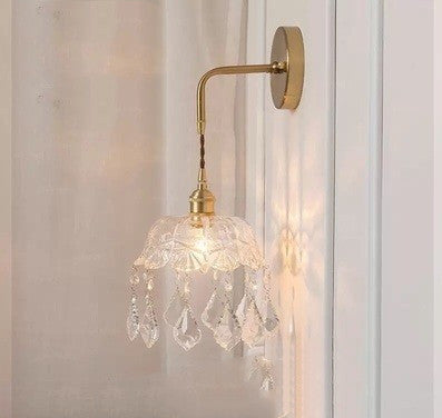 Wall-mounted lamp with crystal details on a light-colored wall