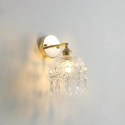 Wall-mounted light fixture with crystal details on a plain wall