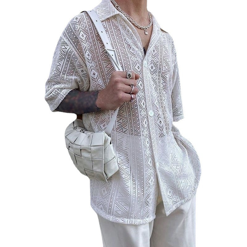 Person wearing a white embroidered shirt with a white bag on a white background