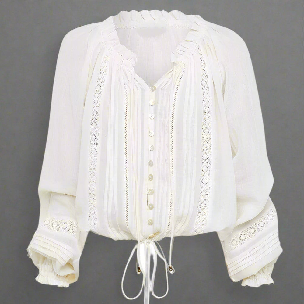 White blouse with lace details on a white background