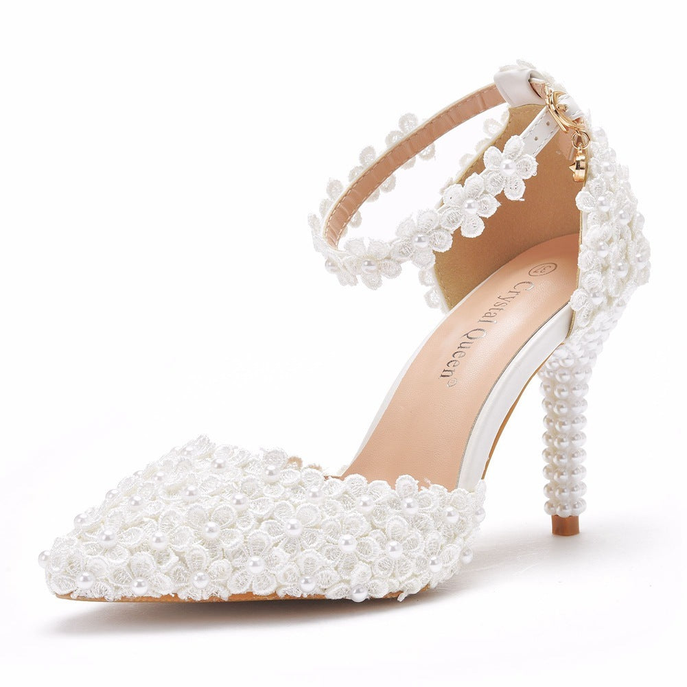White pearl embellished high-heeled shoe on a white background