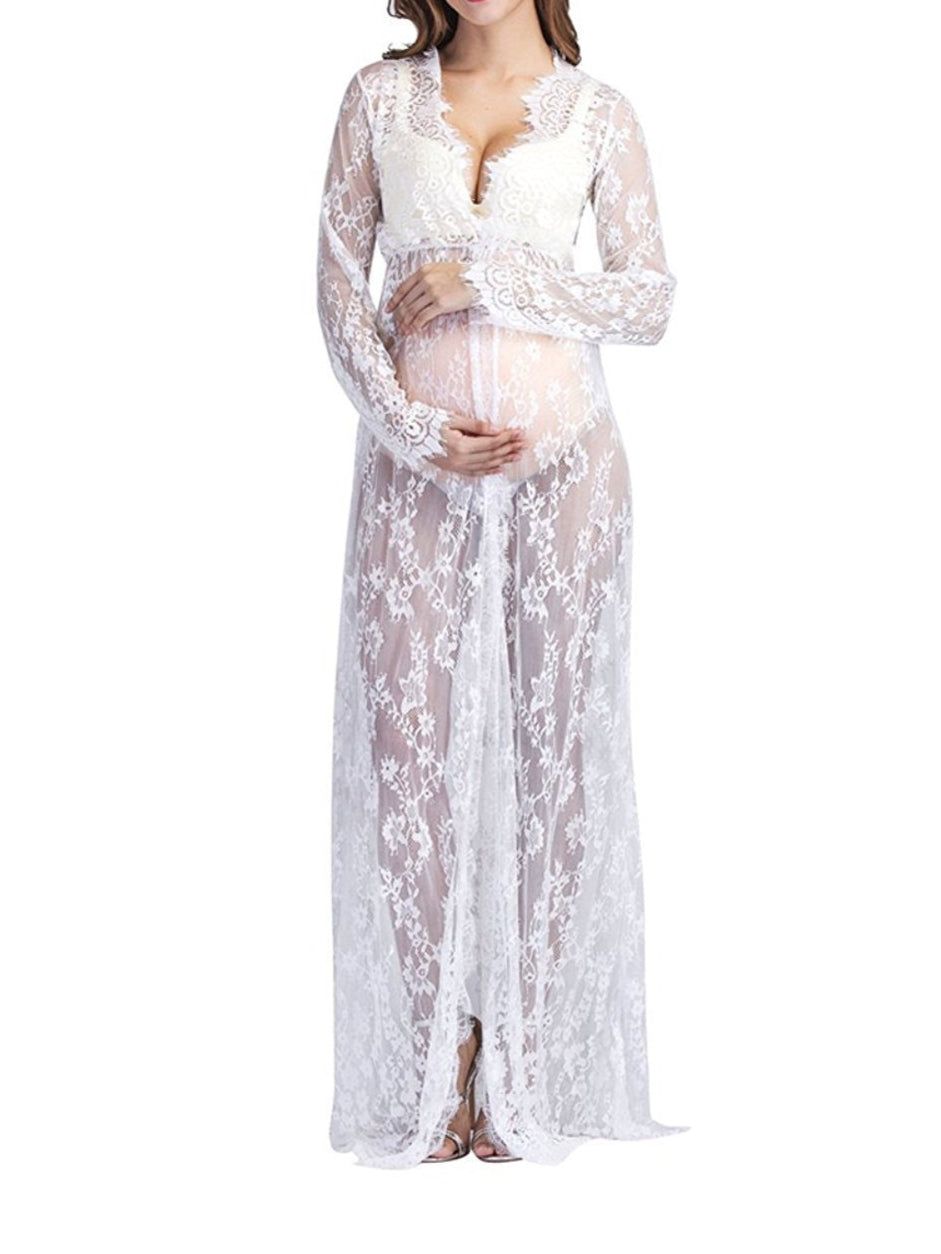 Woman wearing a white lace maternity gown on a white background