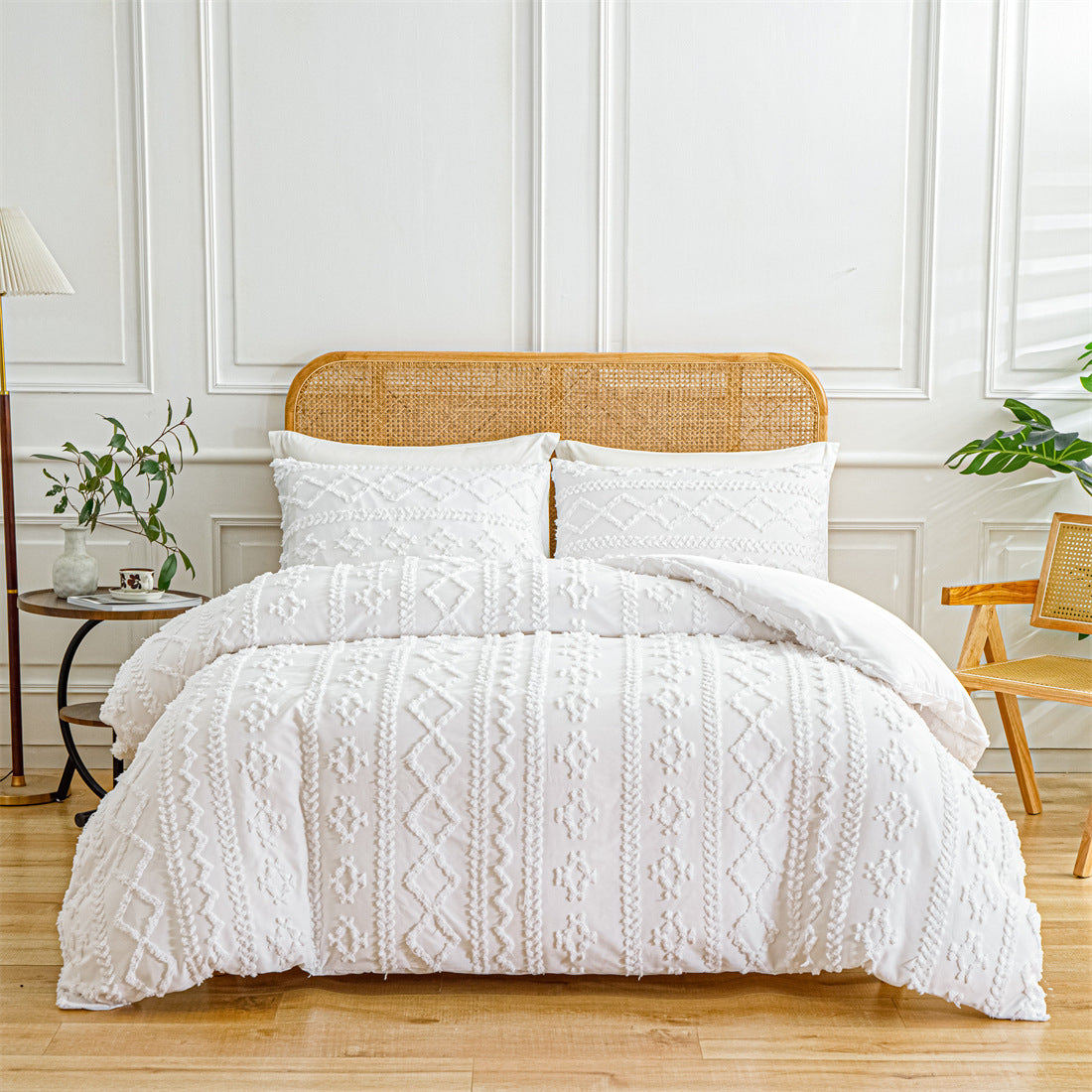 White textured comforter set on a bed with a wooden headboard in a bright room.