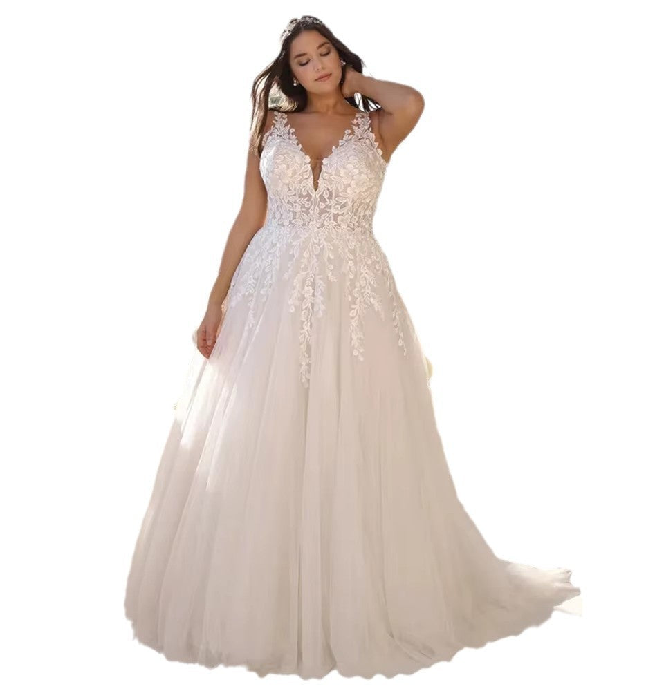 White wedding dress with lace detailing on a white background
