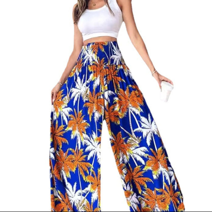 Woman wearing tropical print pants with a white top on a white background