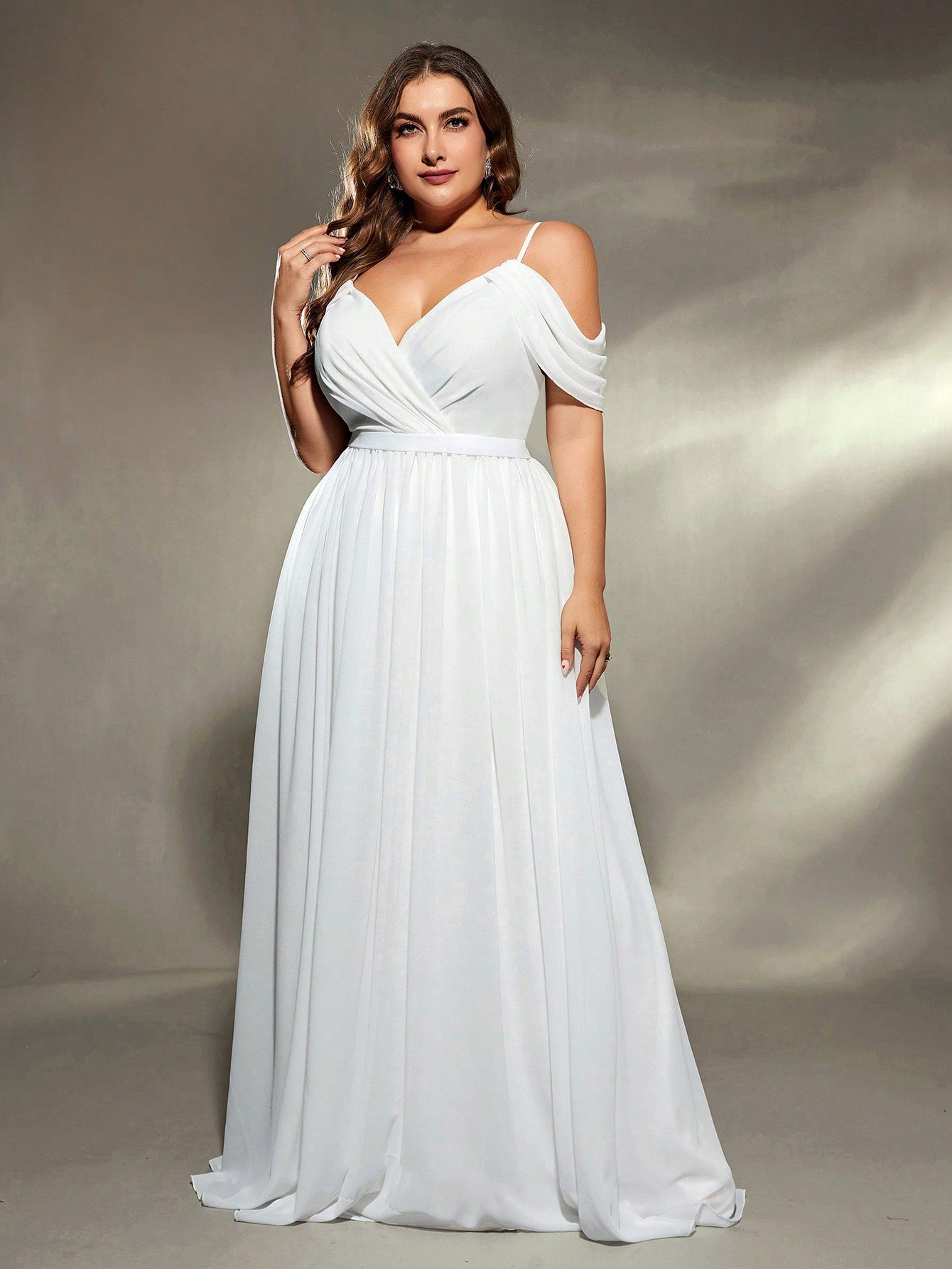 Woman wearing a white evening gown against a neutral background