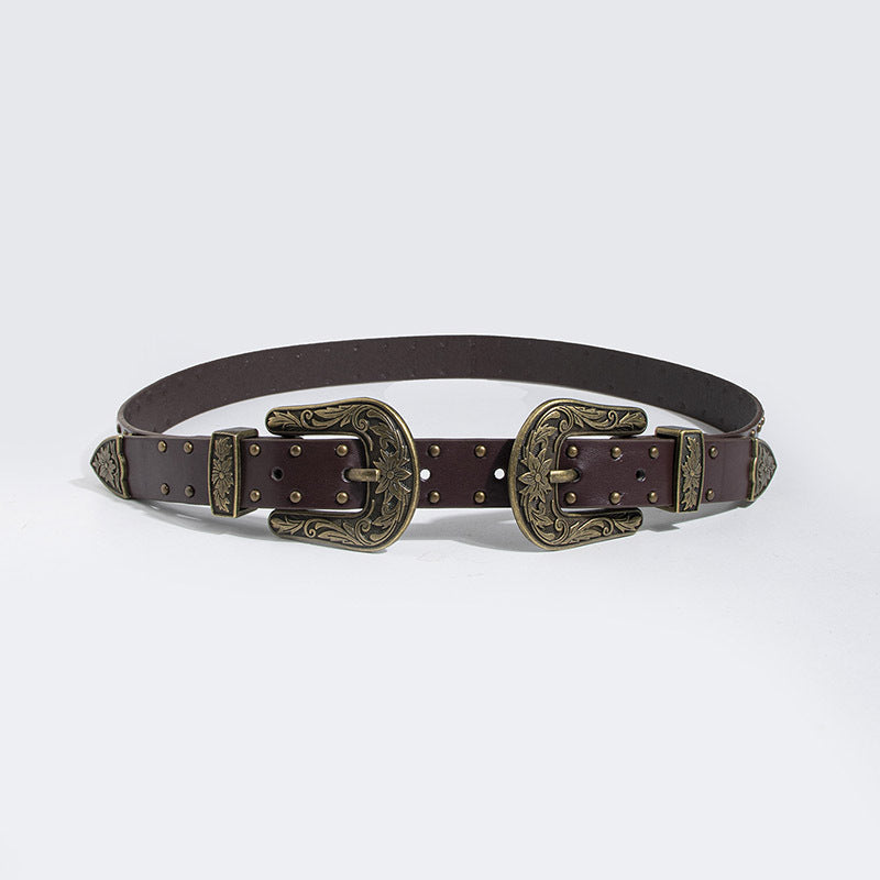 Brown belt with ornate gold buckles on a light gray background