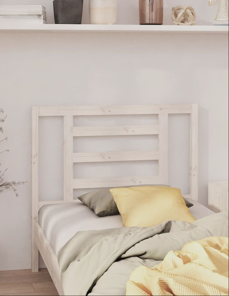 Bedroom with a wooden bed, yellow pillow, and decorative items on a shelf.