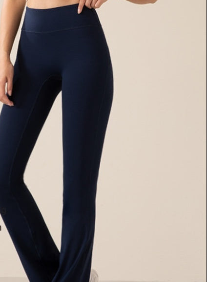 Person wearing navy blue leggings with text on a beige background