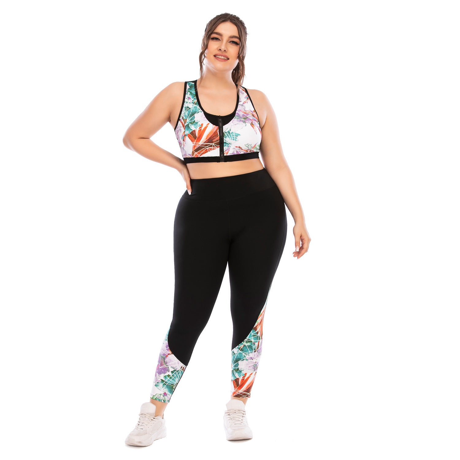 Woman wearing a sports bra and leggings with floral patterns on a white background