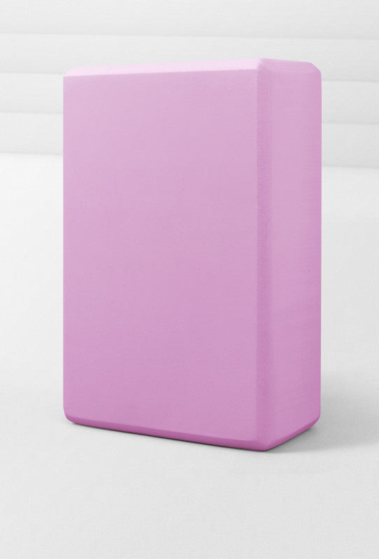 Pink yoga block on a white background