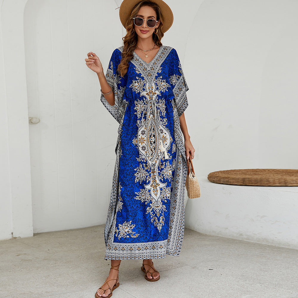 Woman wearing a blue and white patterned dress in a minimal indoor setting