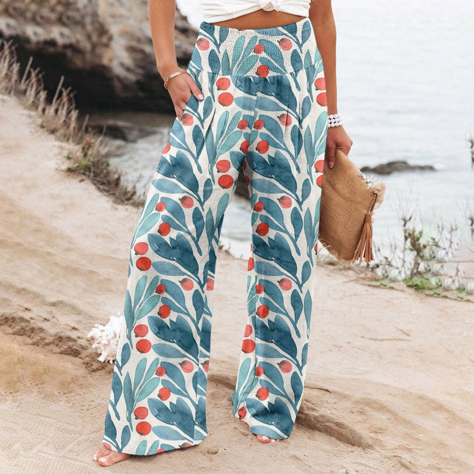 Person wearing floral-patterned pants on a beach