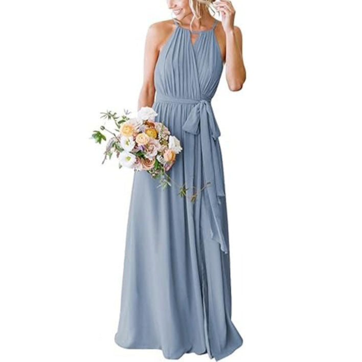 Woman in a long light blue dress holding a bouquet of flowers on a white background