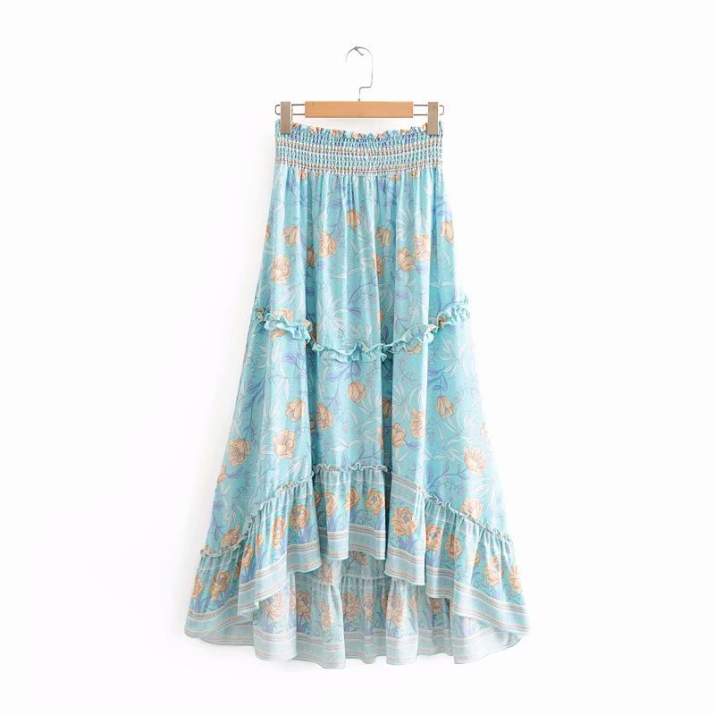Blue floral patterned skirt on a hanger against a white background