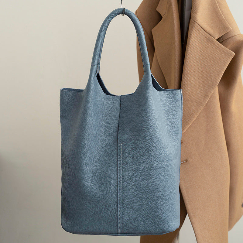 Blue tote bag with a beige background