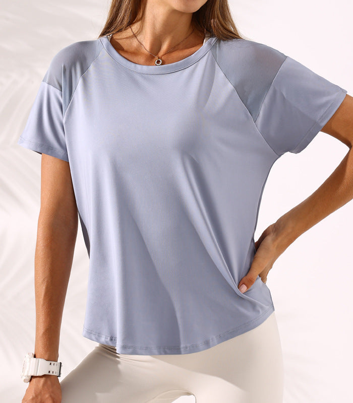 Woman wearing a light blue t-shirt with raglan sleeves on a white background