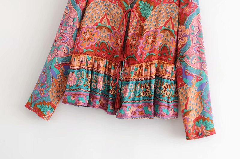 Colorful patterned blouse on a white background