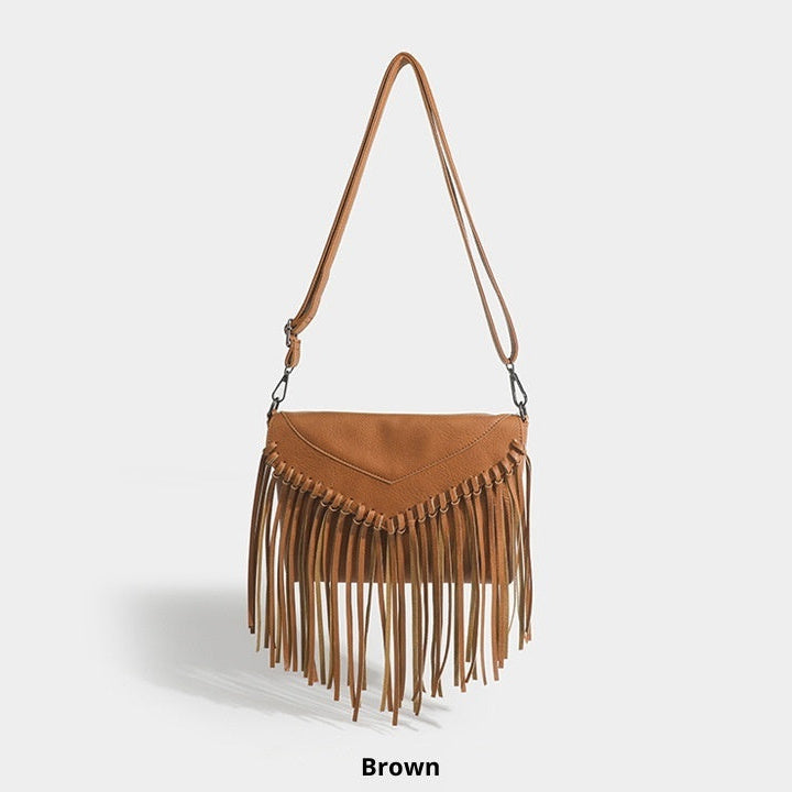 Brown leather handbag with fringe details on a light gray background