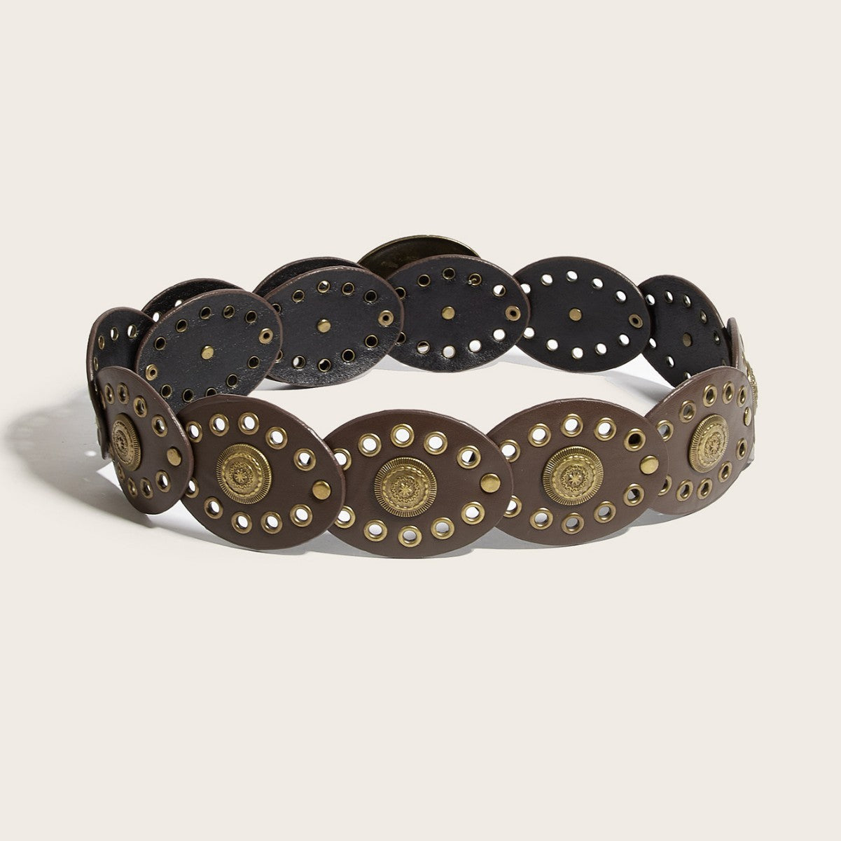 Decorative belt with gold and bronze accents on a beige background