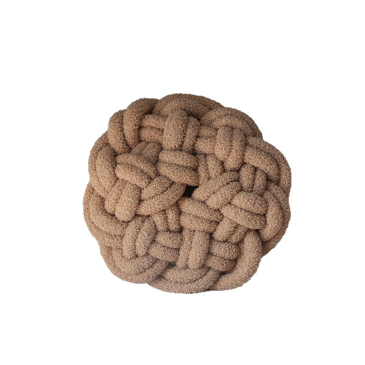 Brown braided ball toy on a white background