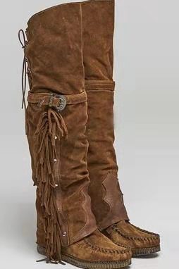 Brown suede boots with fringes and buckles on a white background