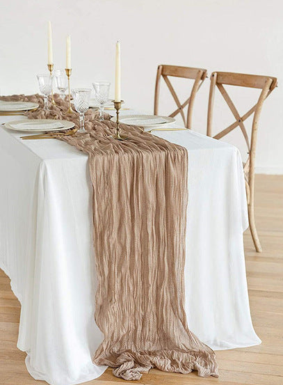 Table setting with a beige ruffled runner and close-up of the fabric texture.
