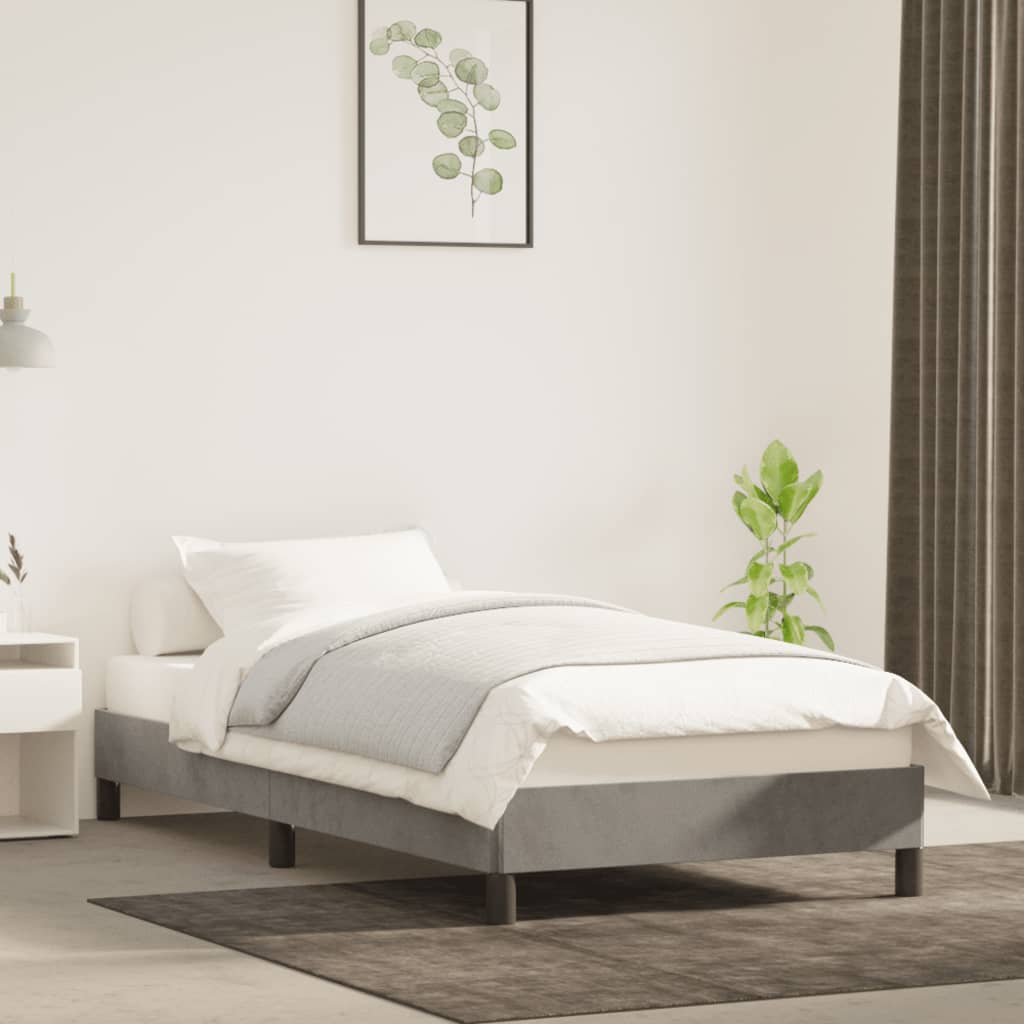 Bedroom with a bed, nightstand, and plant on a light gray rug.